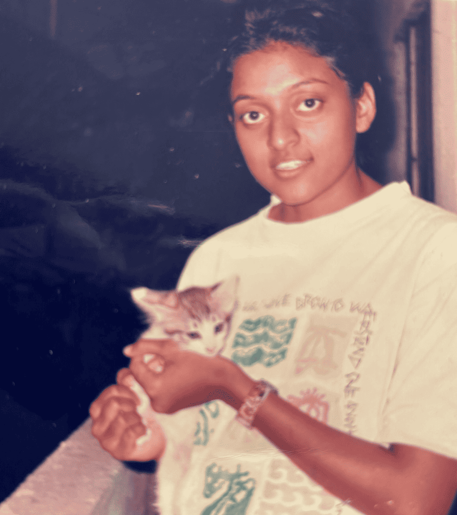 A picture of young Fabida holding her pet cat