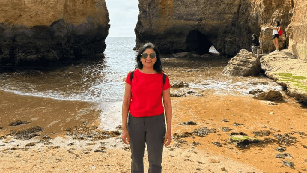 Fabida smiling on a beach in Portugal