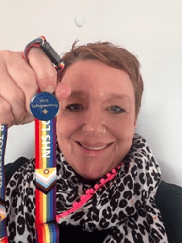 Mel Homer smiling with her badge