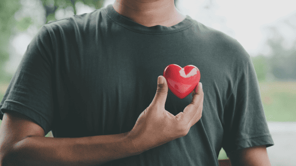 man holding a heart shaped figure