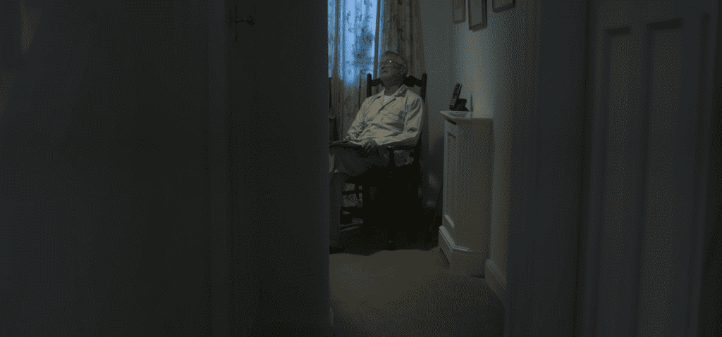 an image of a man sitting alone on a chair