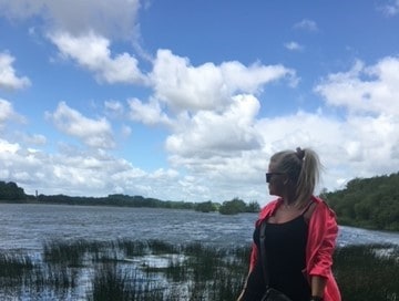 Louise looking at a lake in the distance 