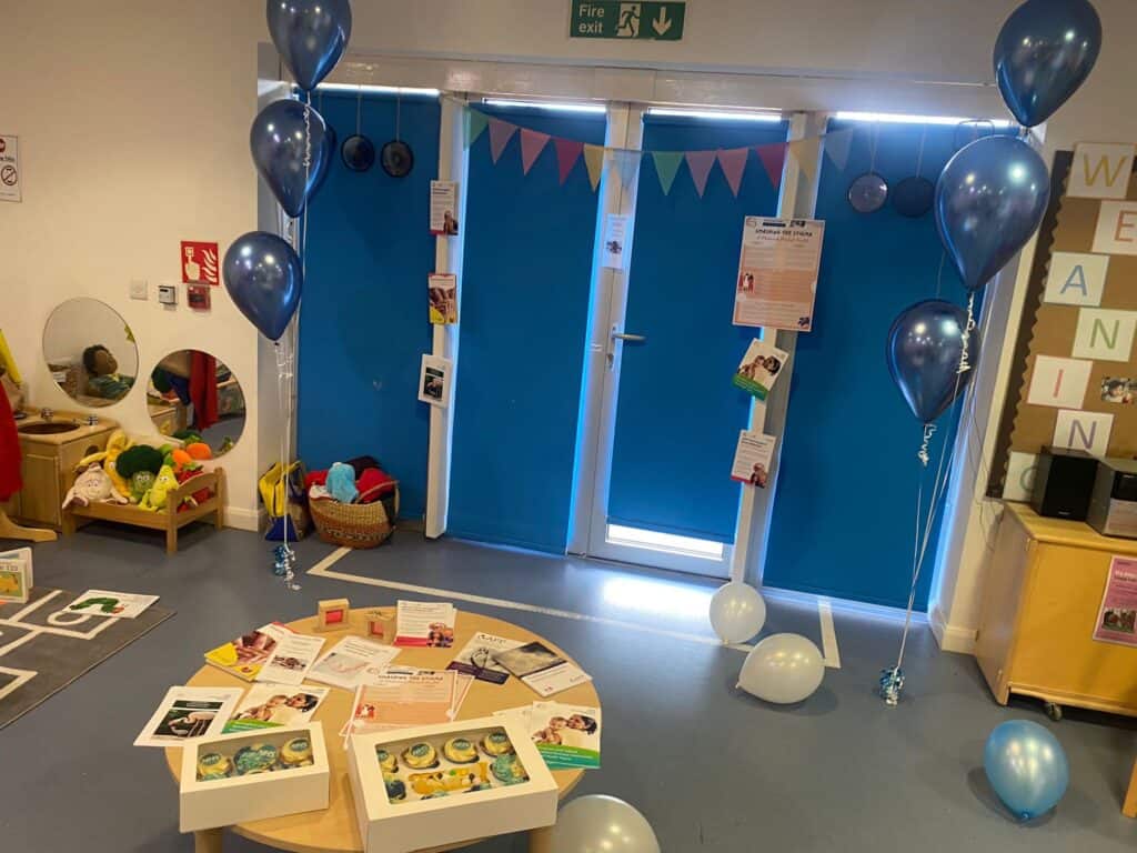 a room with balloons and bunting decorations 