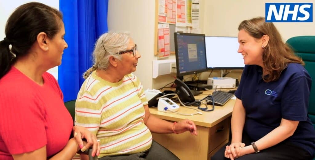 GP doing an Annual Health Check with a patient and their carer