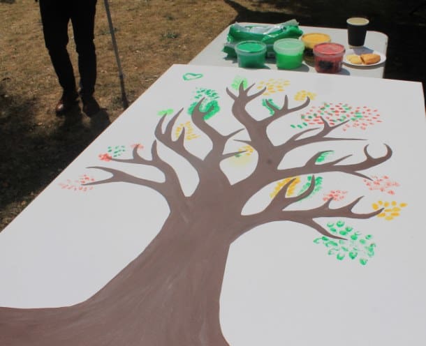 Colorful painted tree on a large white canvas for mental health therapy.